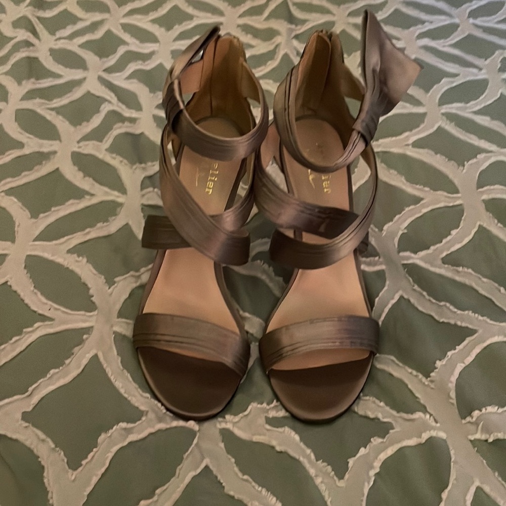 4 inch heels. Bronze with zipper in the back. Now on the side. Never been worn.